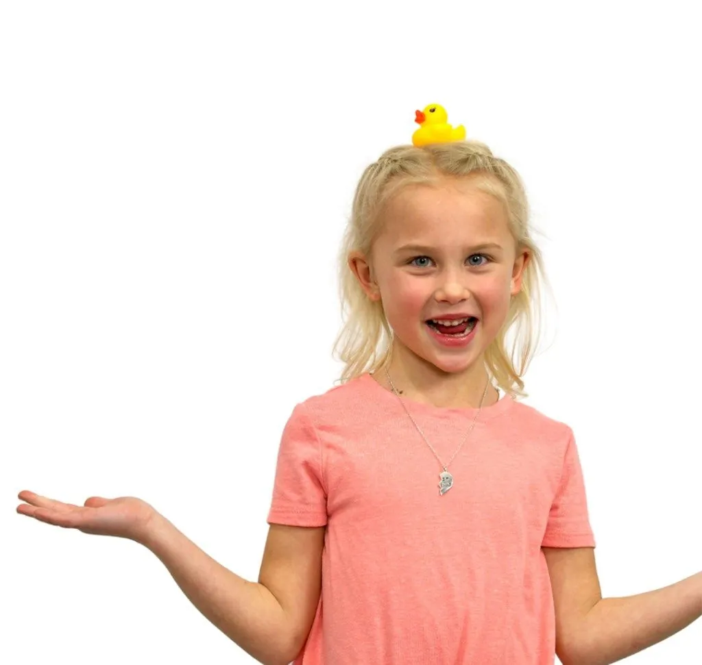 Child with a rubber duck on her head