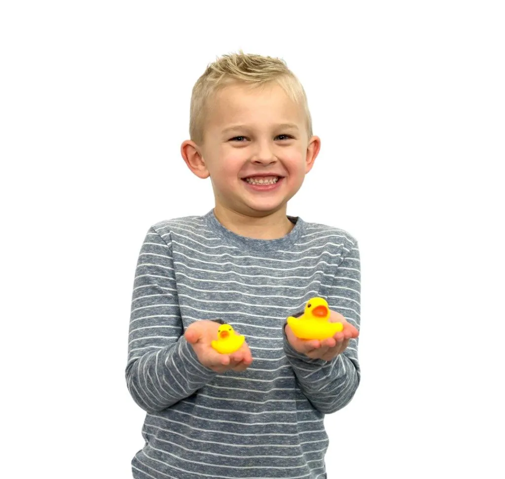 Child holding two rubber ducks