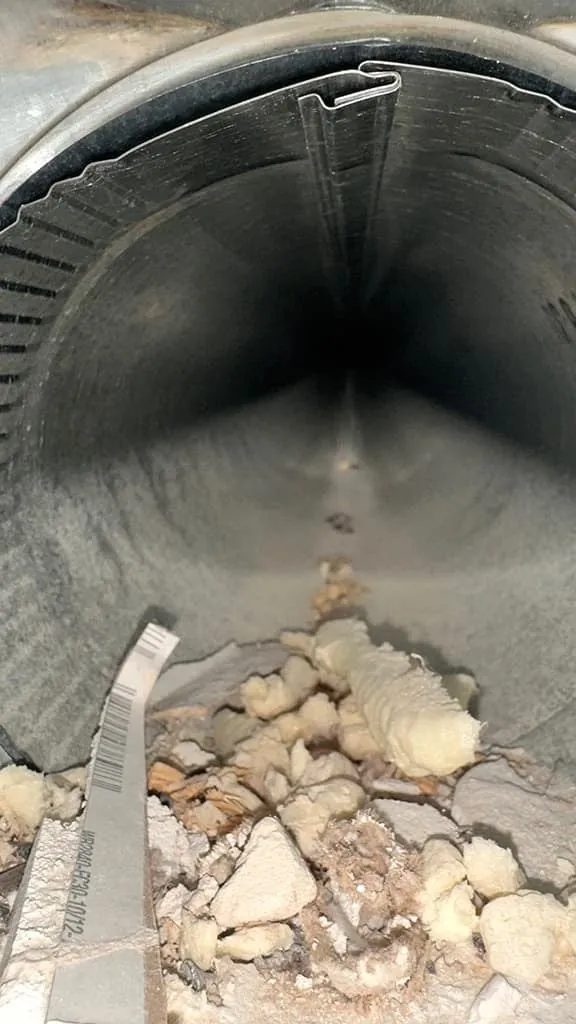 Dust buildup inside an air duct before cleaning