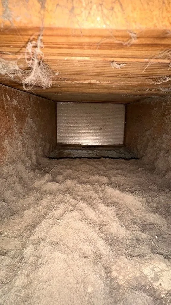 Wooden return duct packed with dust before cleaning