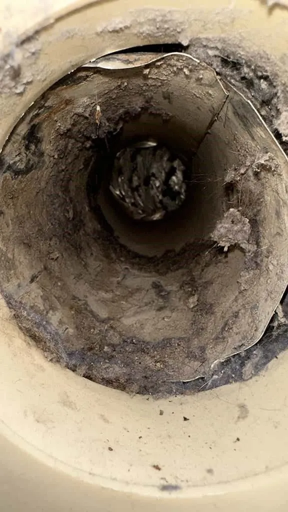 Dryer vent interior packed with lint before cleaning