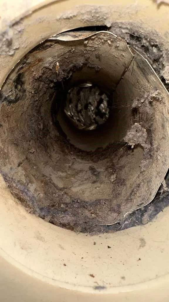 Lint buildup in a dryer vent before cleaning